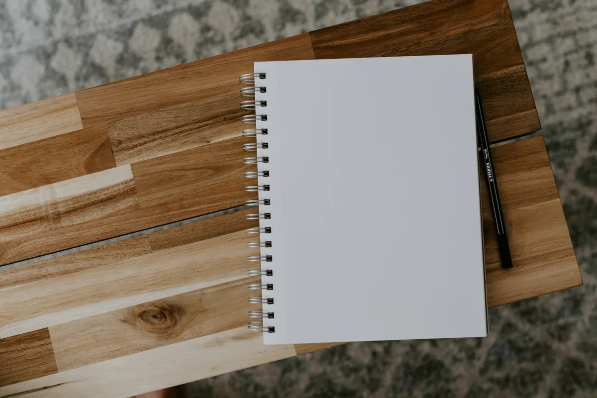 Spiral notebook on a wooden table for self-assessment and mood tracking